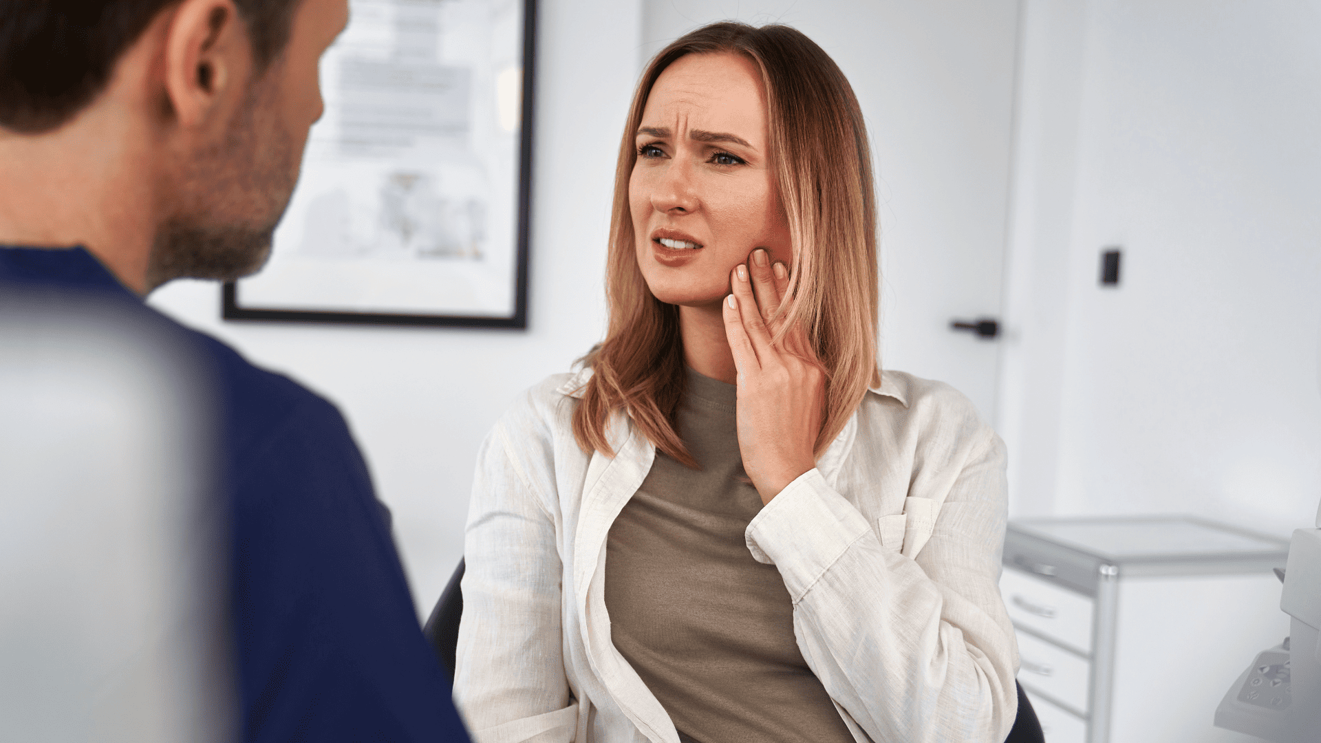 kobieta uciskająca lewą ręką lewy mięsień żwacza