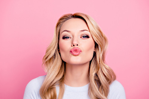 Kobieta z naturalnie powiększonymi i uniesionymi ustami po zabiegu.